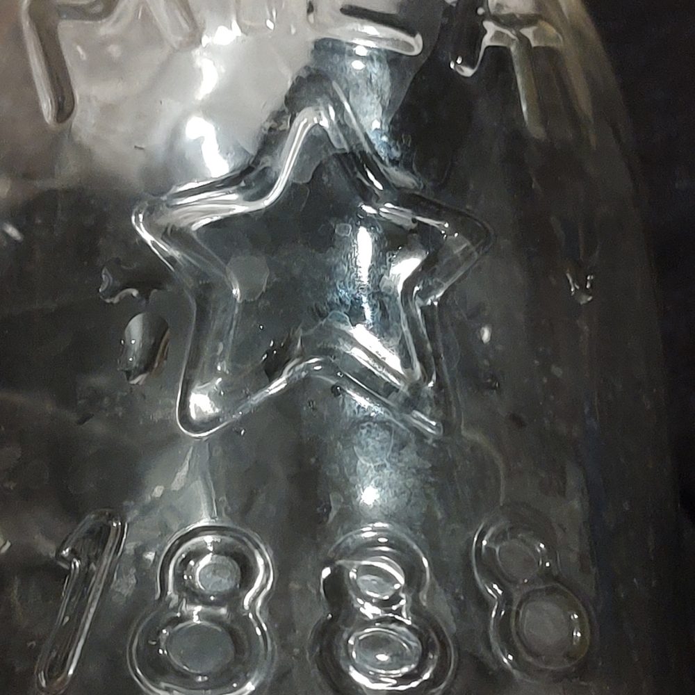Vintage 1 quart glass milk bottle, embossed with an 1888,cow,star, and Canada
